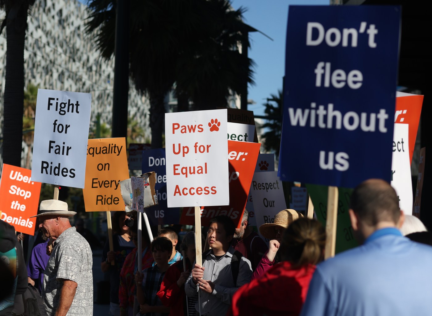 People with blindness and their allies rally outside Uber and Lyft over ride denials